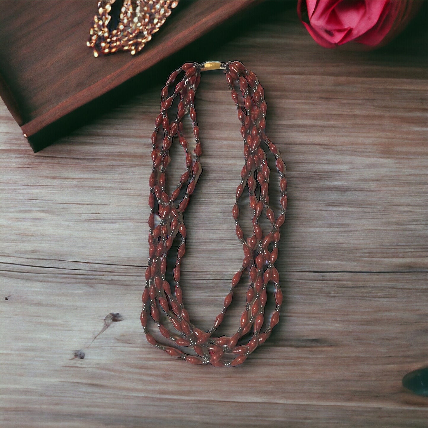 Three-strand necklace made of dozens of itsy bitsy extra tiny little rolled and sealed red paper beads