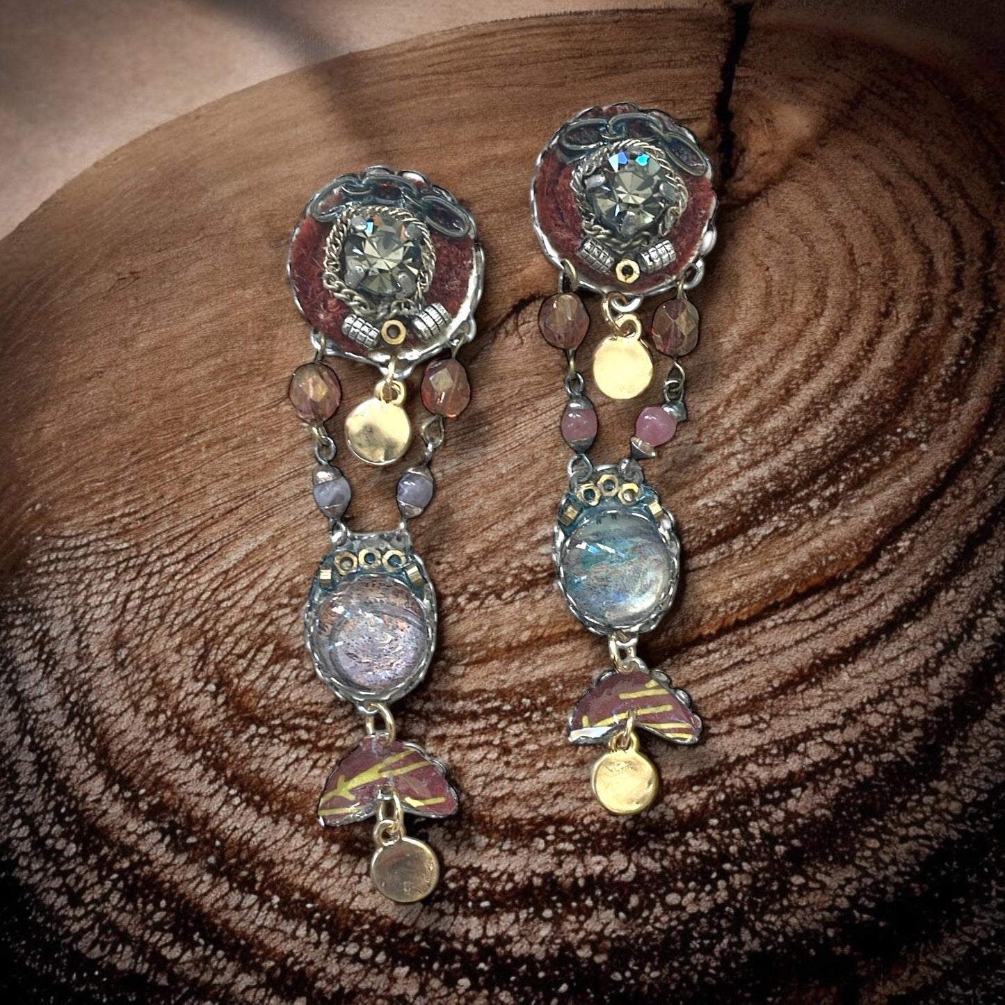 One-of-a-kind earrings made with, paper, fabric, velvet, rhinestones, chain, mixed metals and postage stamp remnants. Sterling ear wires.