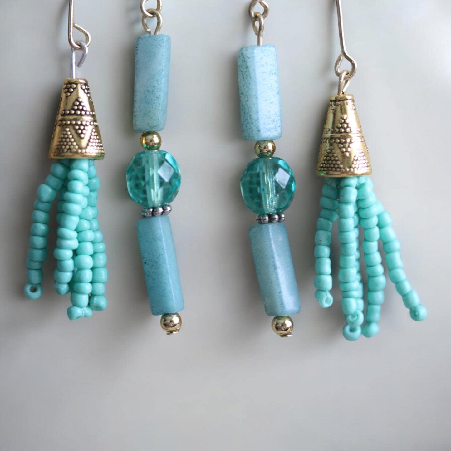 Asymmetrical mixed material turquoise crystal, stone and seed beads with goldtone trim - 2 and one-half" long earrings