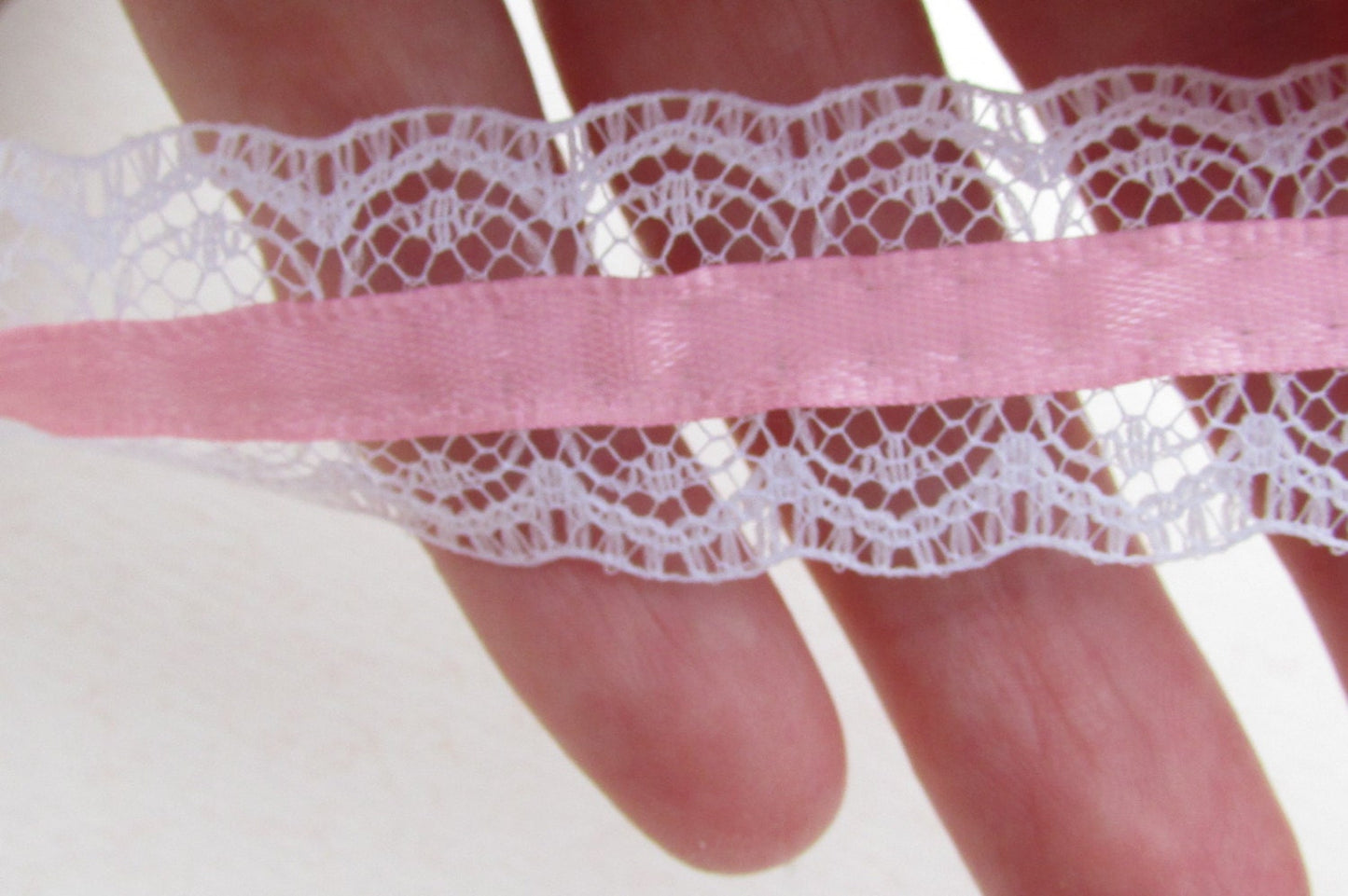 Victorian-style vintage narrow white lace with pink ribbon in the center - by the yard