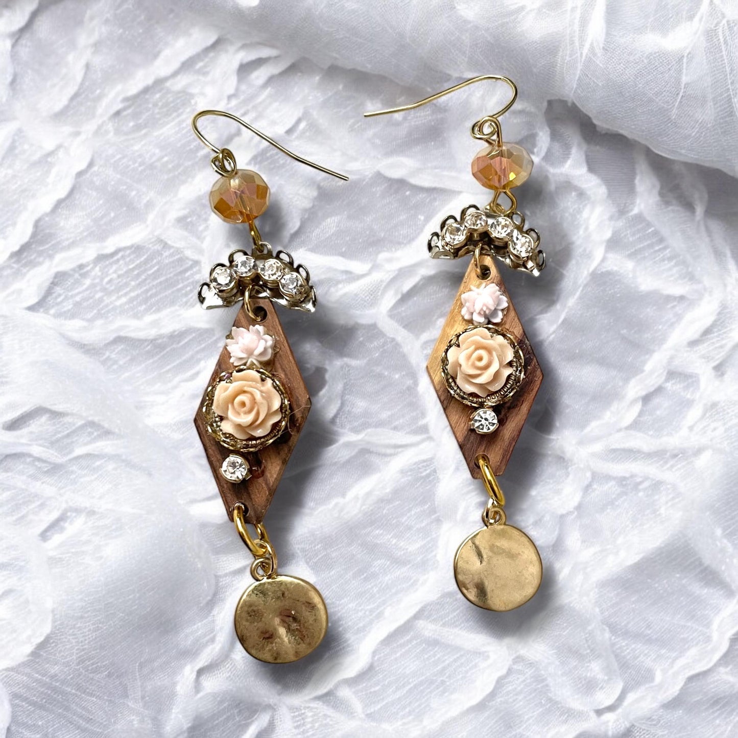 Dangle earrings with wood diamonds from a broken vintage rosary, etched roses, rhinestone, crystals and hammered discs. Sterling ear wires.