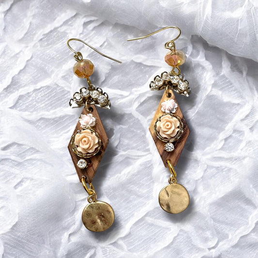 Dangle earrings with wood diamonds from a broken vintage rosary, etched roses, rhinestone, crystals and hammered discs. Sterling ear wires.