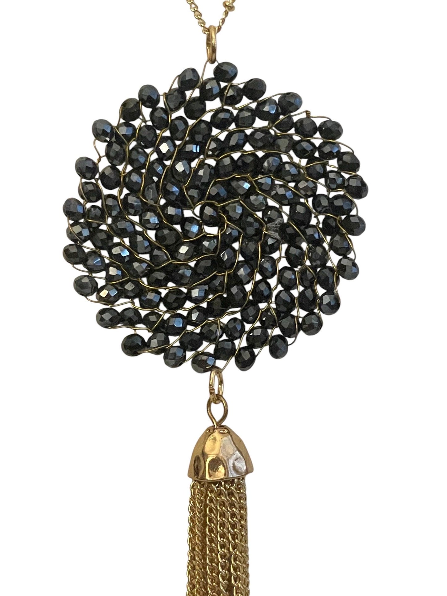 Vintage necklace featuring a black crystal wire linked circular pendant with long goldtone tassel