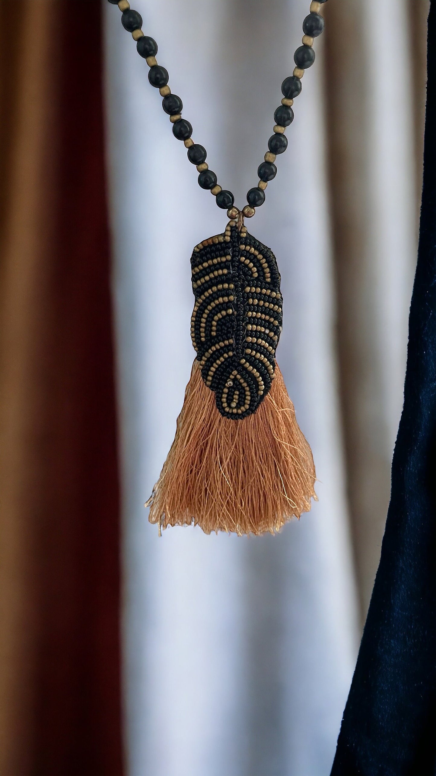Stunning and unique hand beaded vintage artisan black and gold tassel necklace