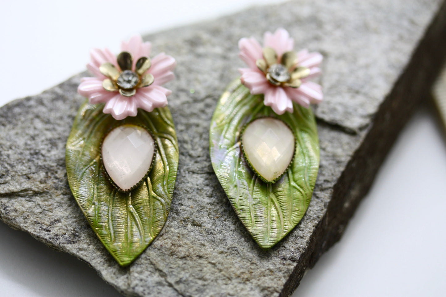 Hand painted leaf earrings with inlaid cabochan, vintage mixed material pink and metal flowers and capped off with rhinestone center