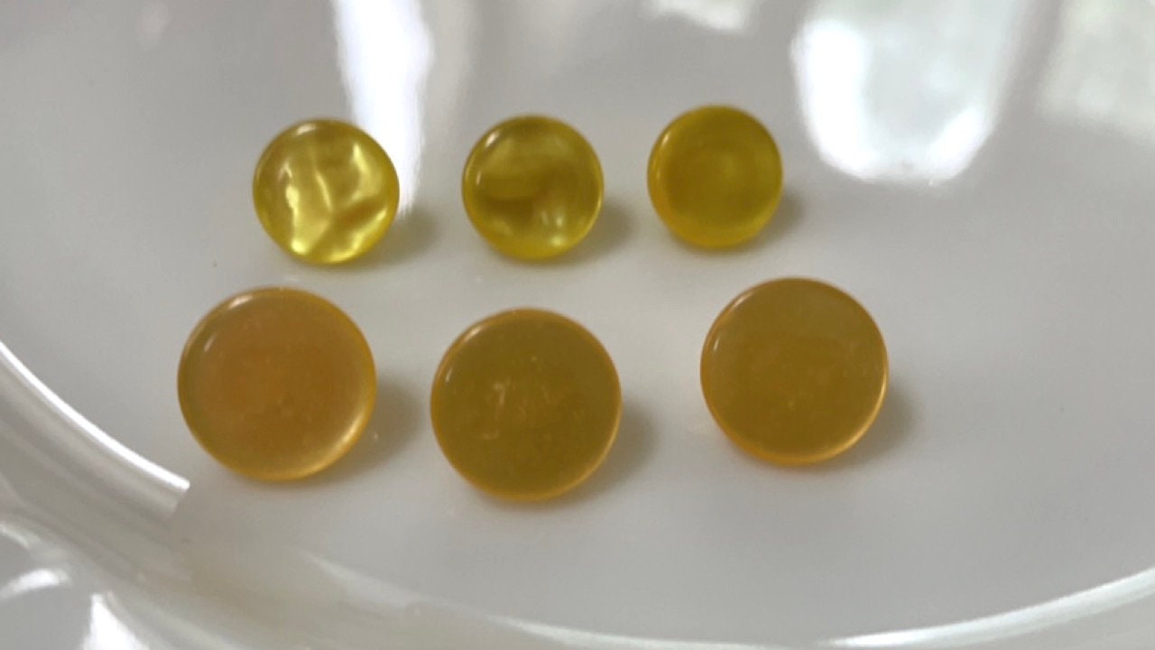 One dozen round yellow gold pearlescent vintage buttons