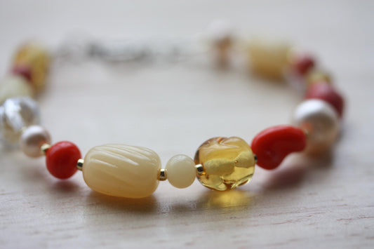 Handmade beaded bracelet featuring uniquely twisted orange vintage glass, amber colored crystal, pink pearls and etched striped beads - 7"