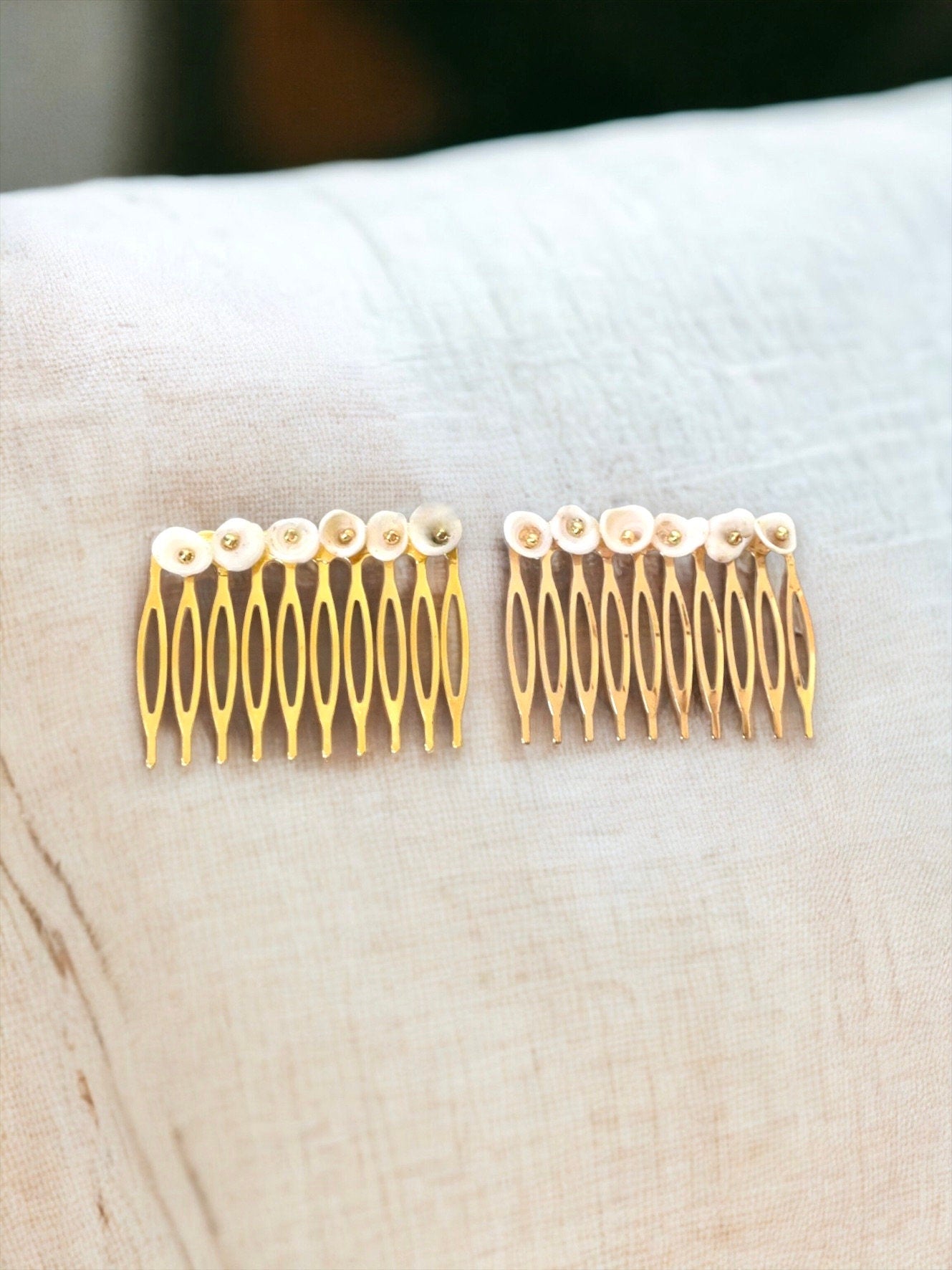 Pair of ivory white shell hair combs with goldtone centers