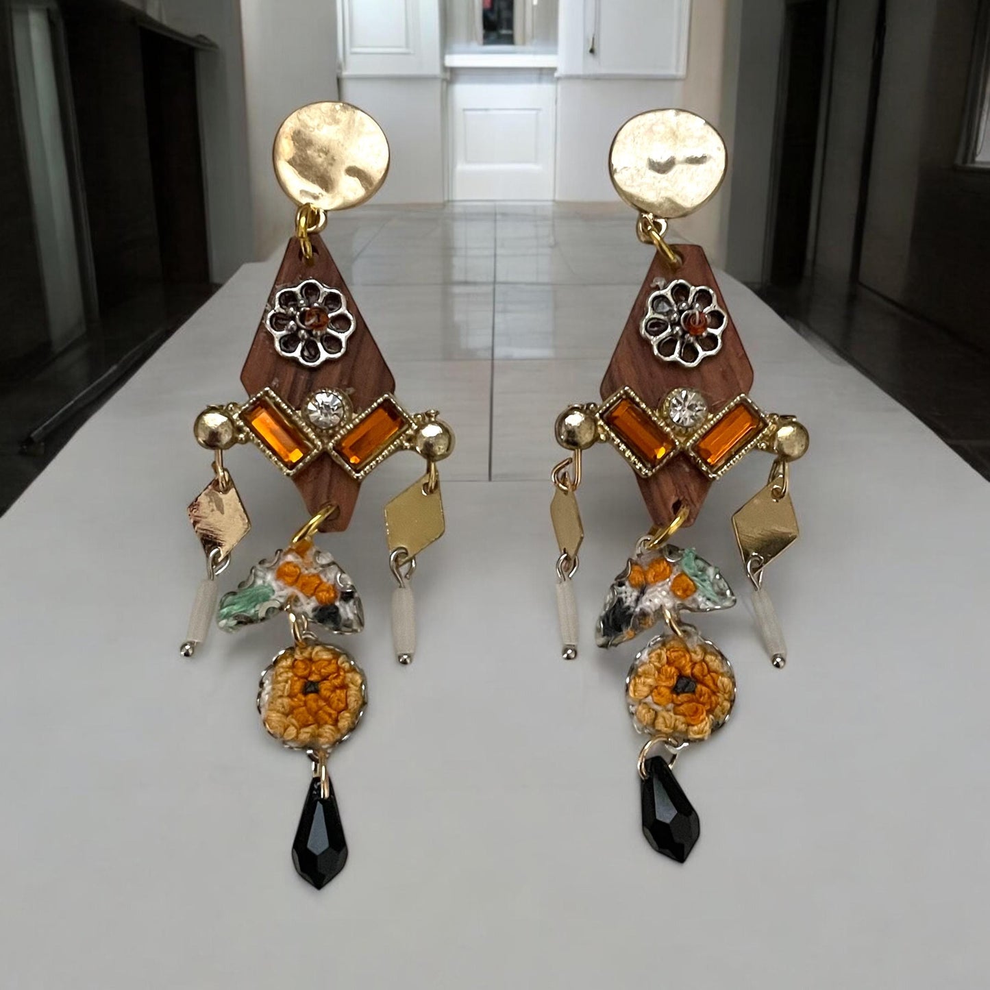 Mixed media earrings made with embroidery from a vintage linen table runner,  rosary wood, hammered metal, glass tubes, orange rhinestones