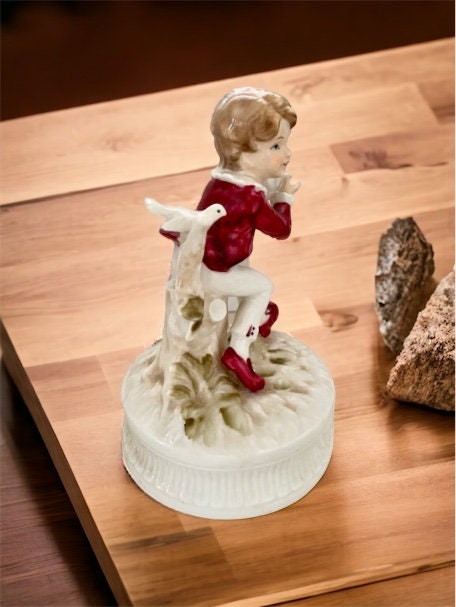1977 Berman and Anderson stunning porcelain music box - boy dressed in red and white feeding birds