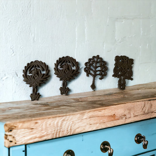 Set of 4 small cast iron trivets - vintage or antique?