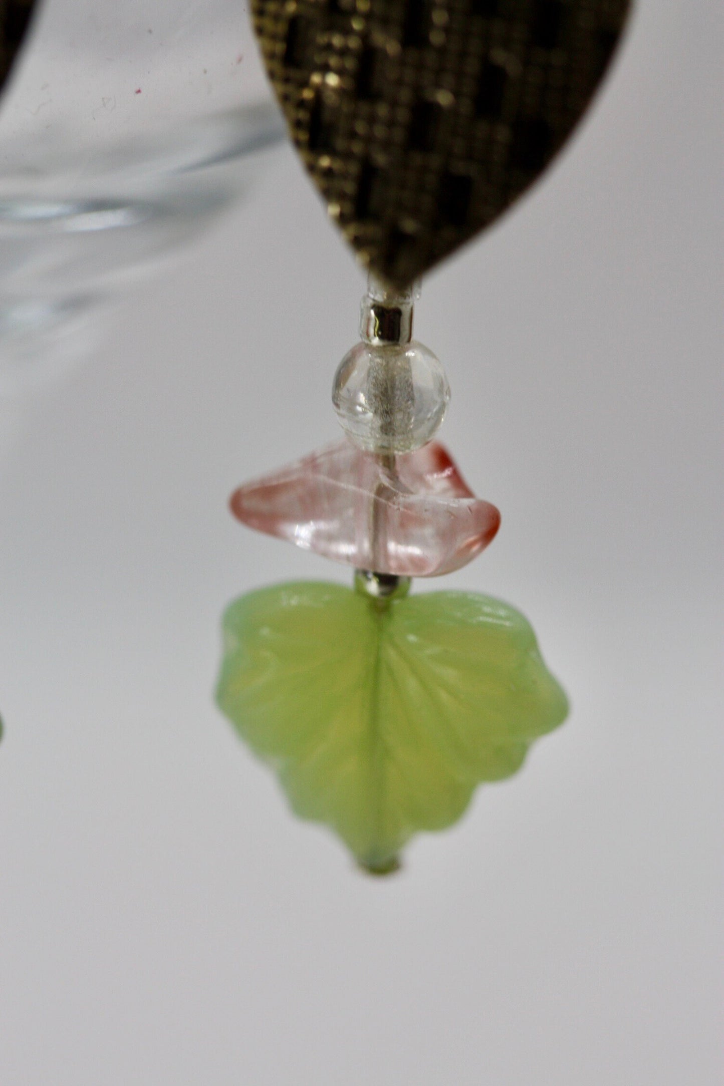 Handmade dangle earrings made of vintage textured metal leaves, pink gemstone chips and light green opaline glass ginko flower leaves