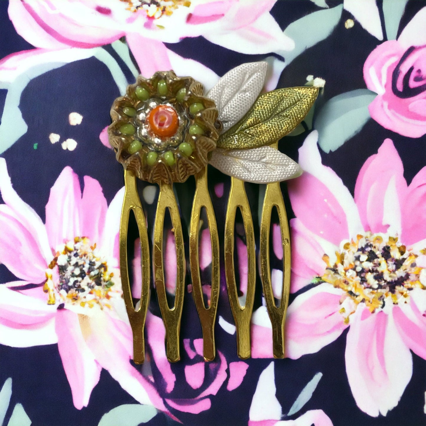 Small 1" hair comb featuring beaded mixed medium upcycled metal floral crown trimmed with satin green and white leaves.