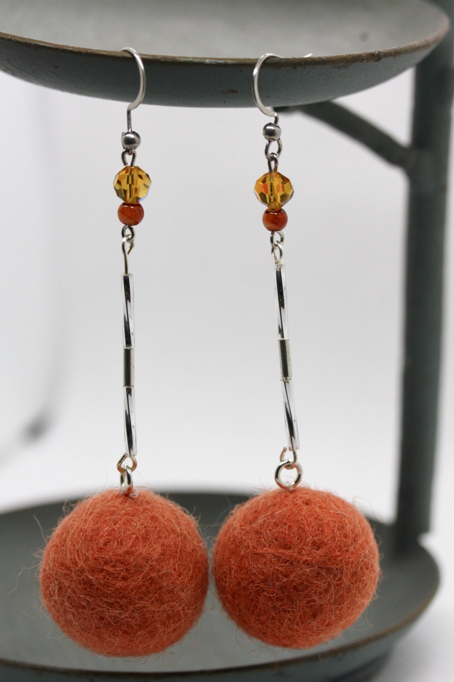 Long, 3.5 inch dangle earrings featuring purchased handmade sheep farm felt coupled with my beedwork