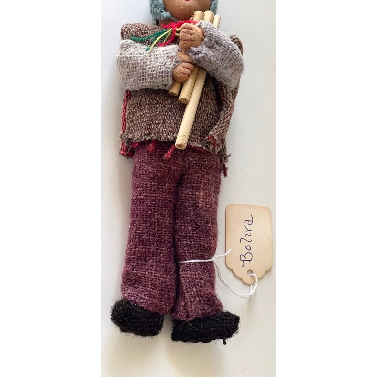 Vintage Bolivian man playing panpipes - collectible folk art doll with handmade woven wool clothing