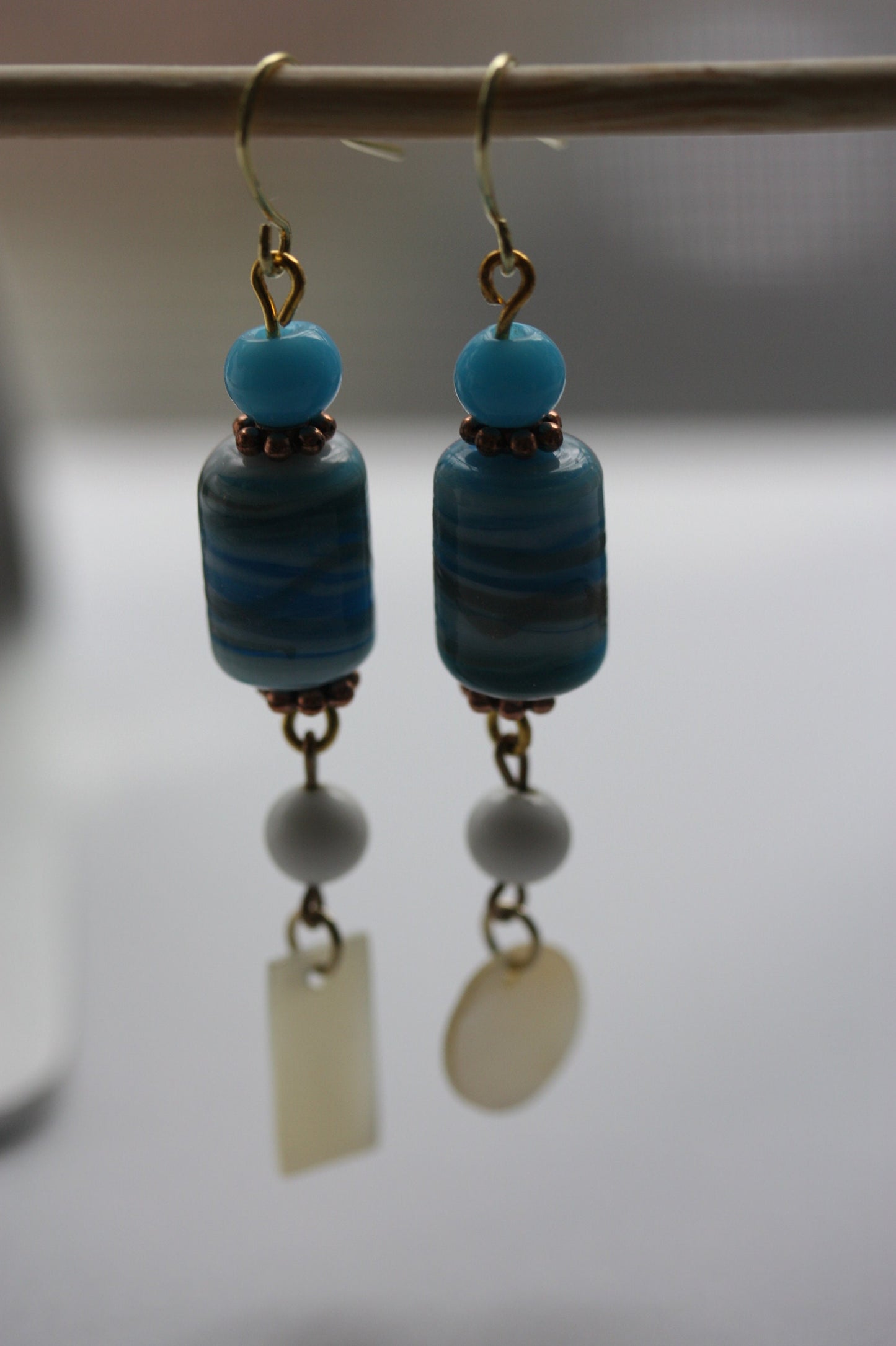 Long dangle earrings made of both new and vintage components -blue and gold art glass, mother of pearl dangles,vintage blue and white beads