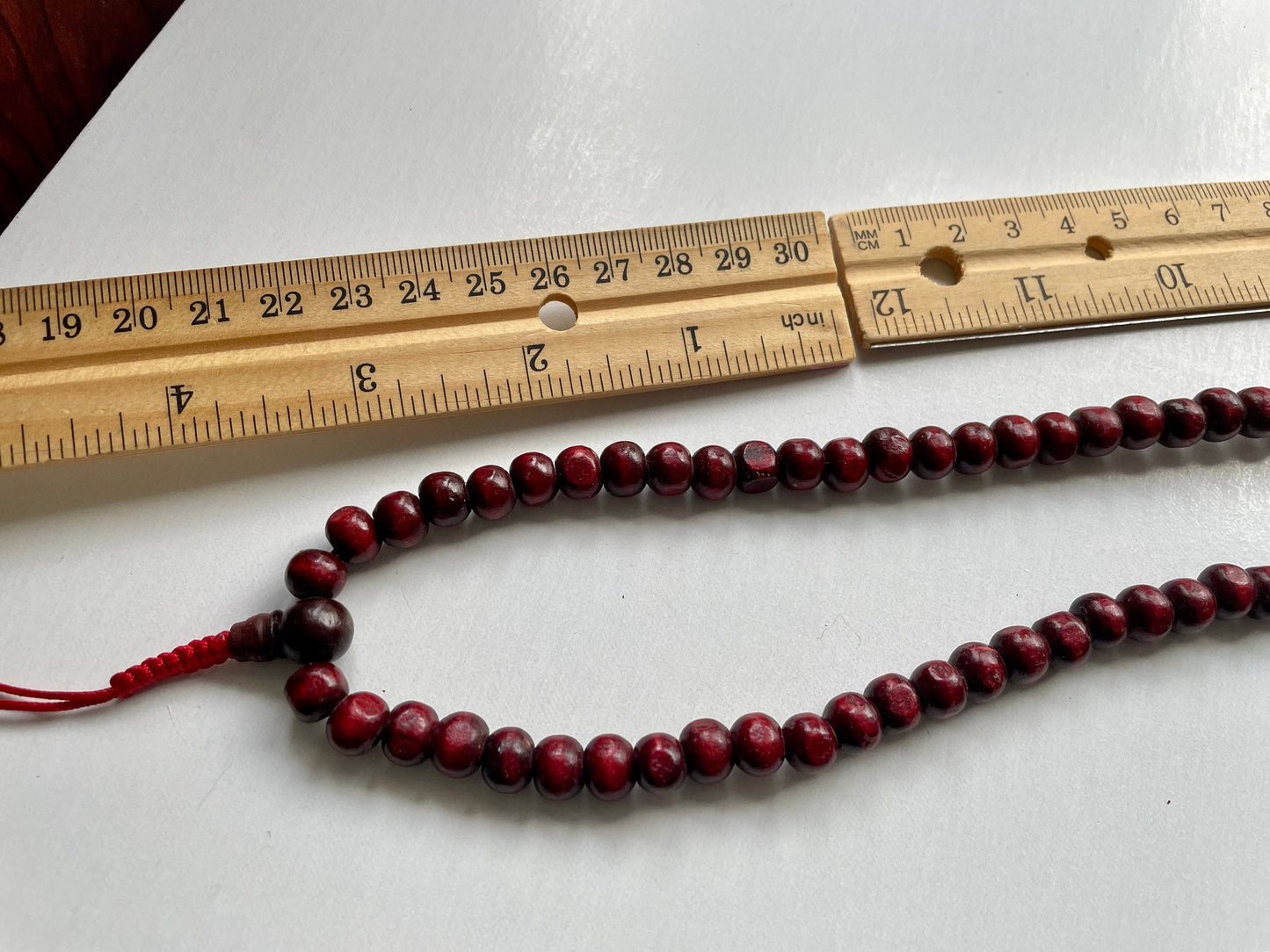 Long turquoise and wood vintage beaded necklace on red satin