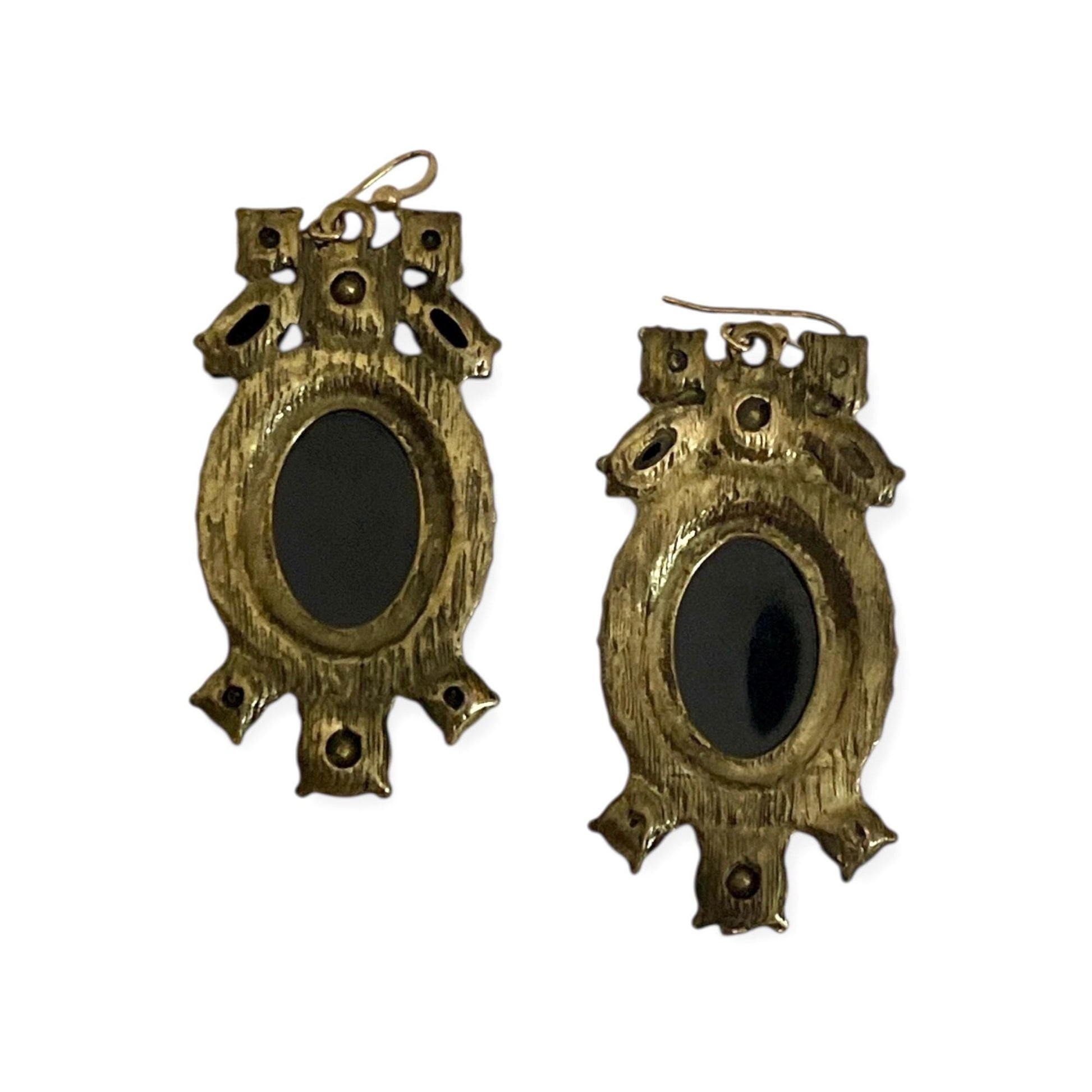 a pair of ornate, antique-style earrings with a gold-colored metal design.