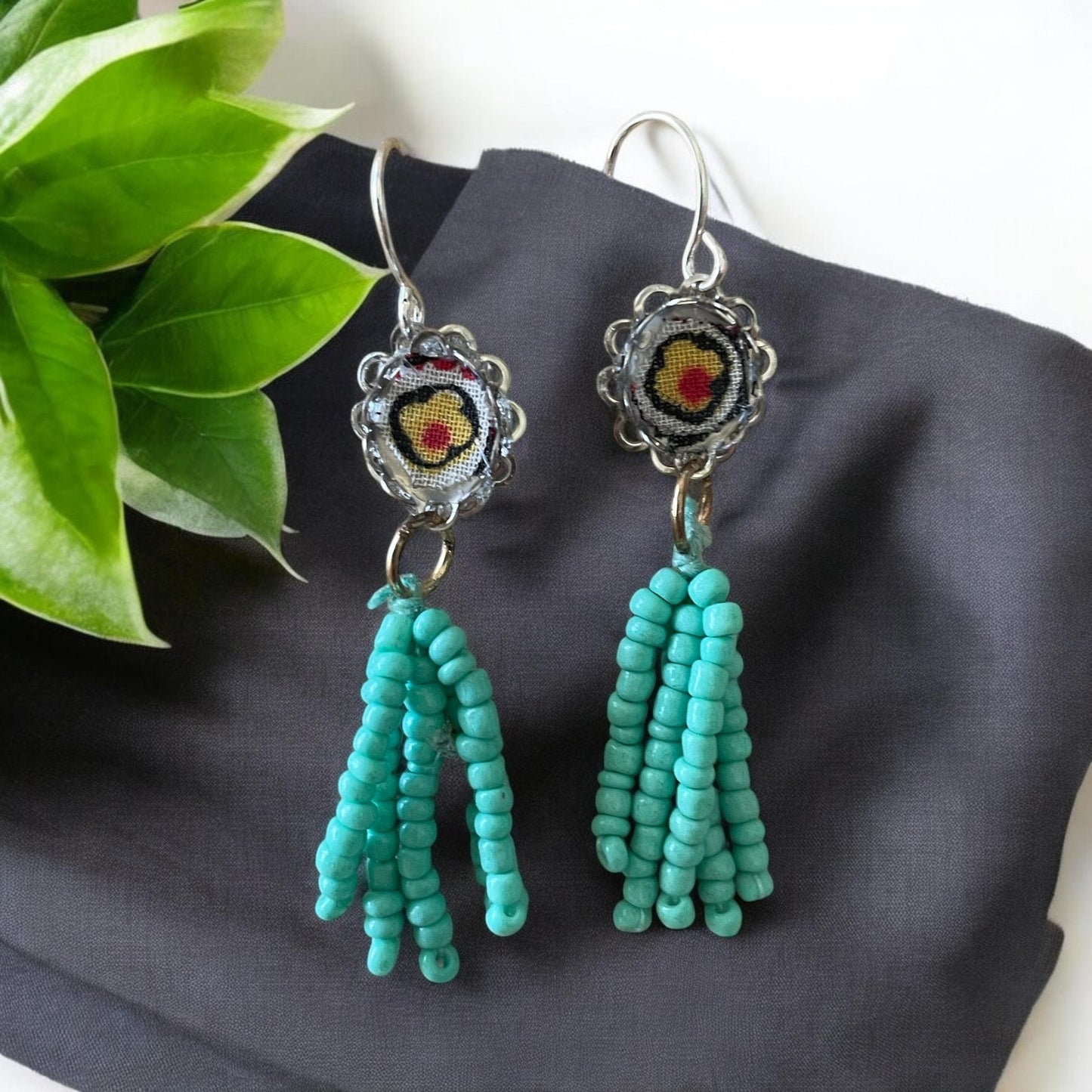 Handmade mixed media earrings featuring beaded turquoise tassel combined with vintage fabric snippets.  Sterling silver ear wire.