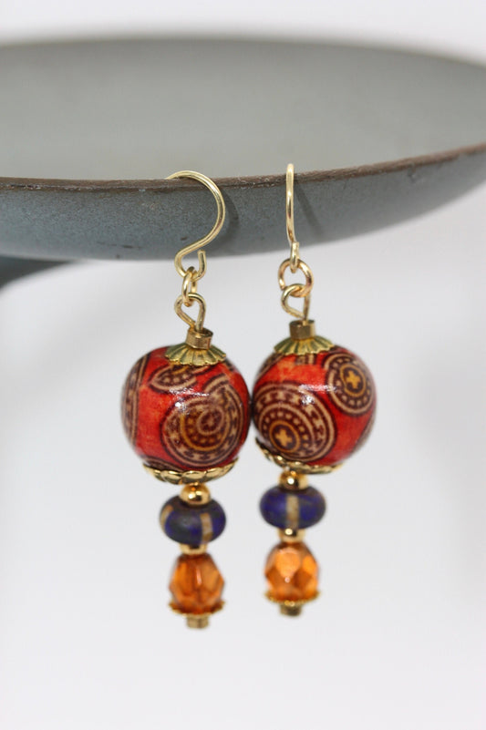 Burnt orange beaded earrings - paper covered beads, purple with cream stripes, orange fire polished crystals