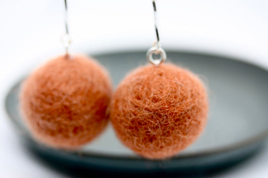 Long, 3.5 inch dangle earrings featuring purchased handmade sheep farm felt coupled with my beedwork