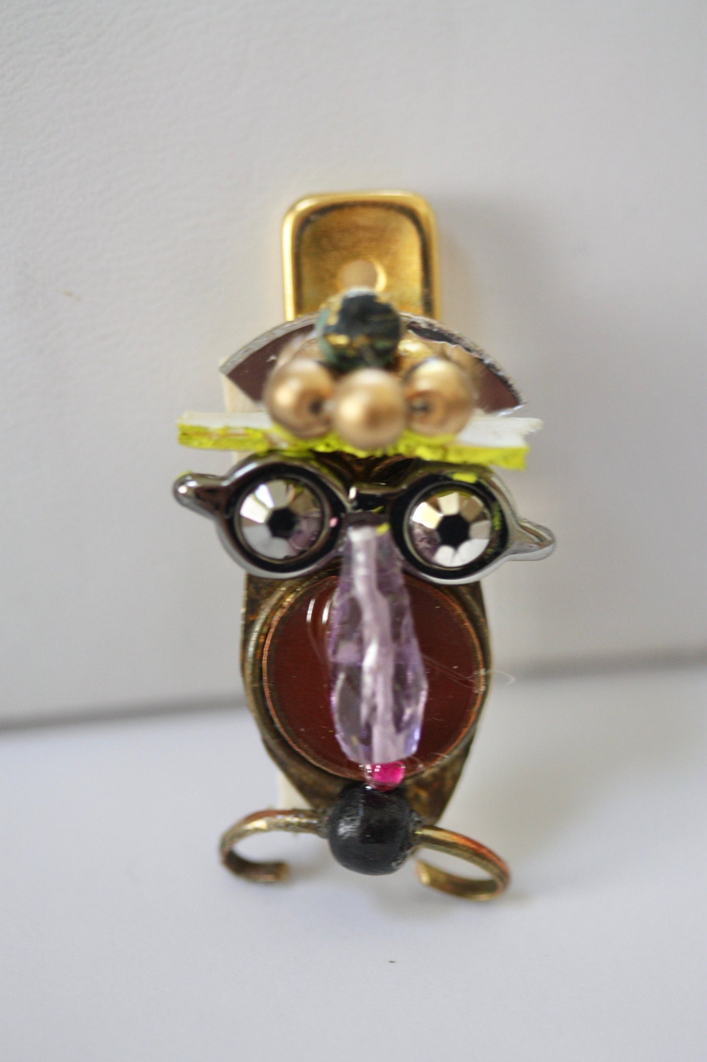 Meet "Henrietta."  Henrietta is a really cool assemblage art gal who can be transformed into a necklace, pin, magnet, bottle or little dish