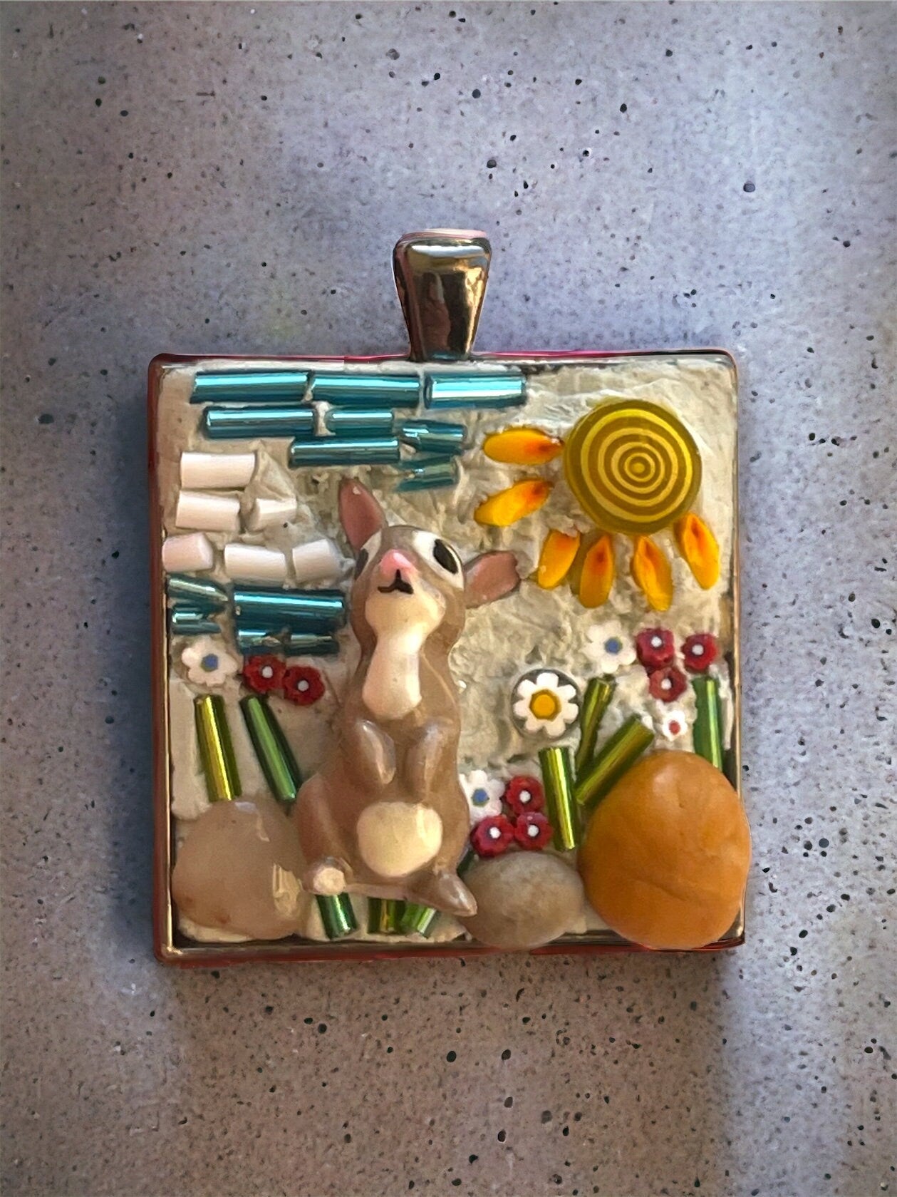 Handmade mixed material micro mosaic necklace - bone china rabbit sitting in sunshine with flowers, grass and rocks (from the Jersey shore)