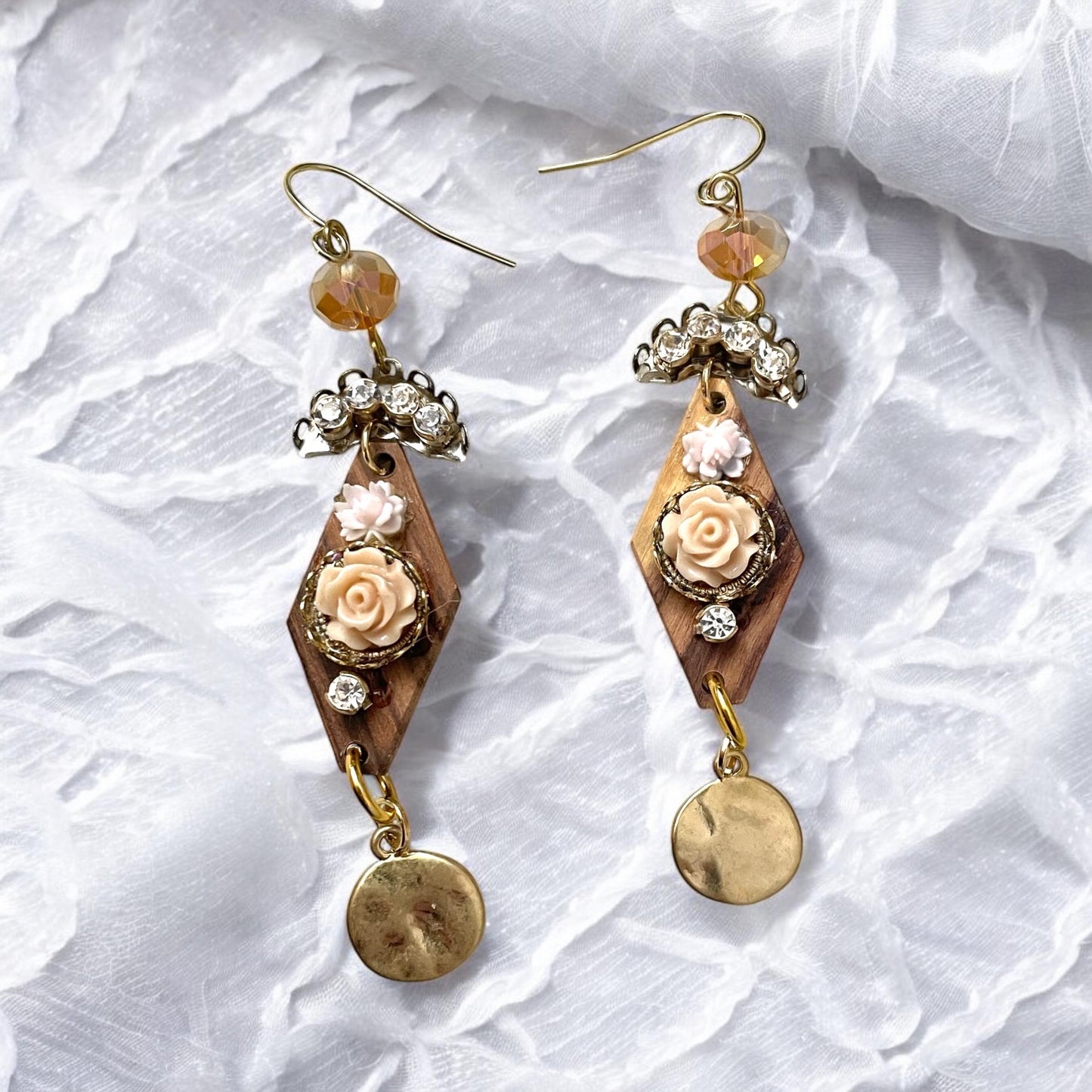 Dangle earrings with wood diamonds from a broken vintage rosary, etched roses, rhinestone, crystals and hammered discs. Sterling ear wires.