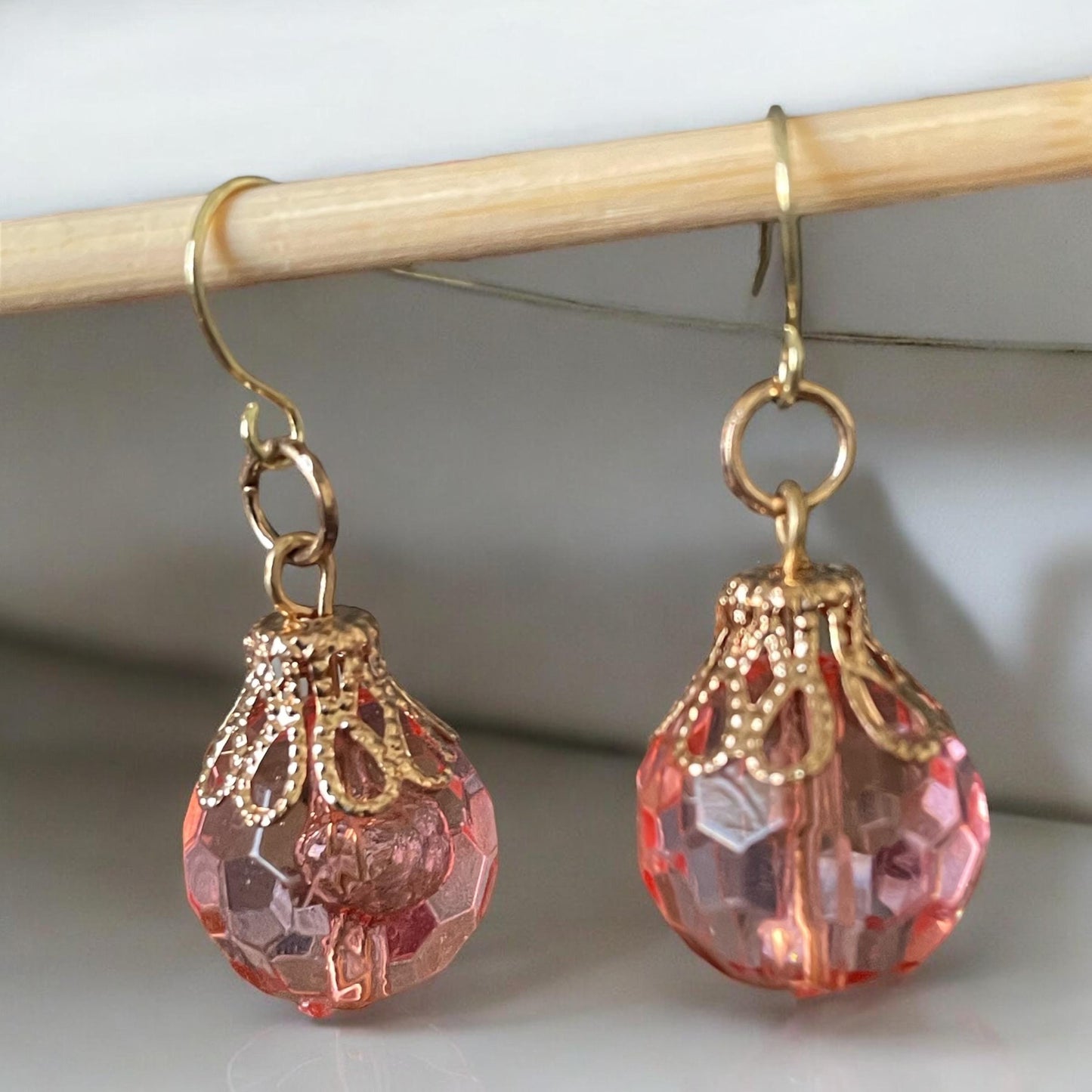 Pink faceted faux crystal earrings with goldstone filigree