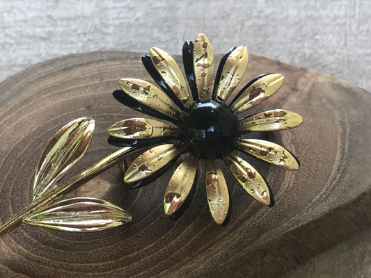 Large, long stemmed goldtone vintage flower pin with black center