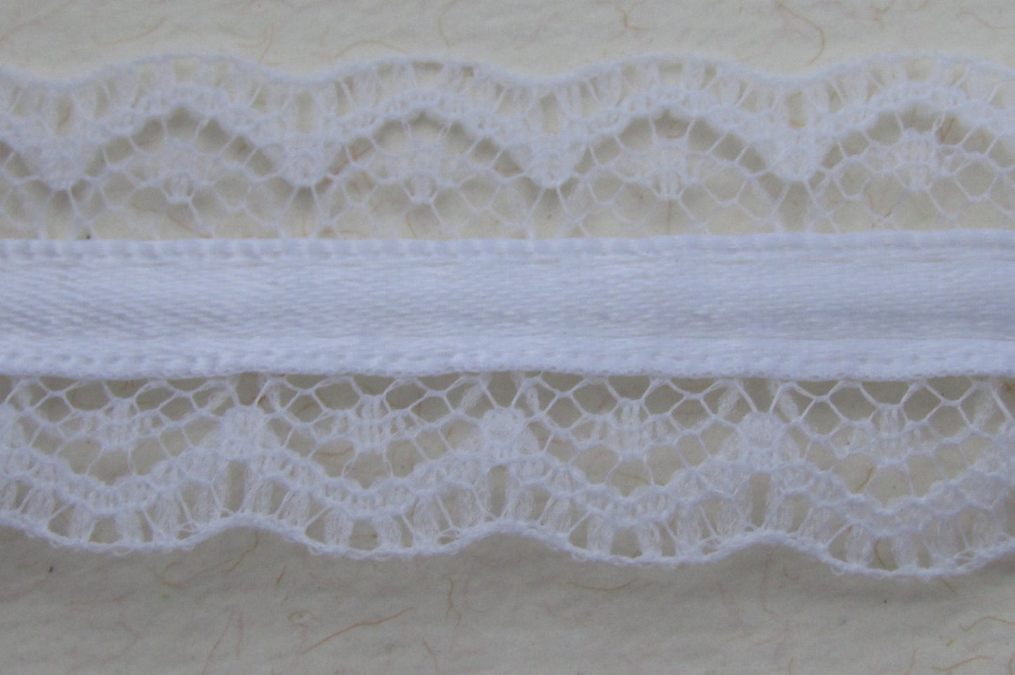 Victorian-style vintage narrow white lace with white ribbon in the center - by the yard