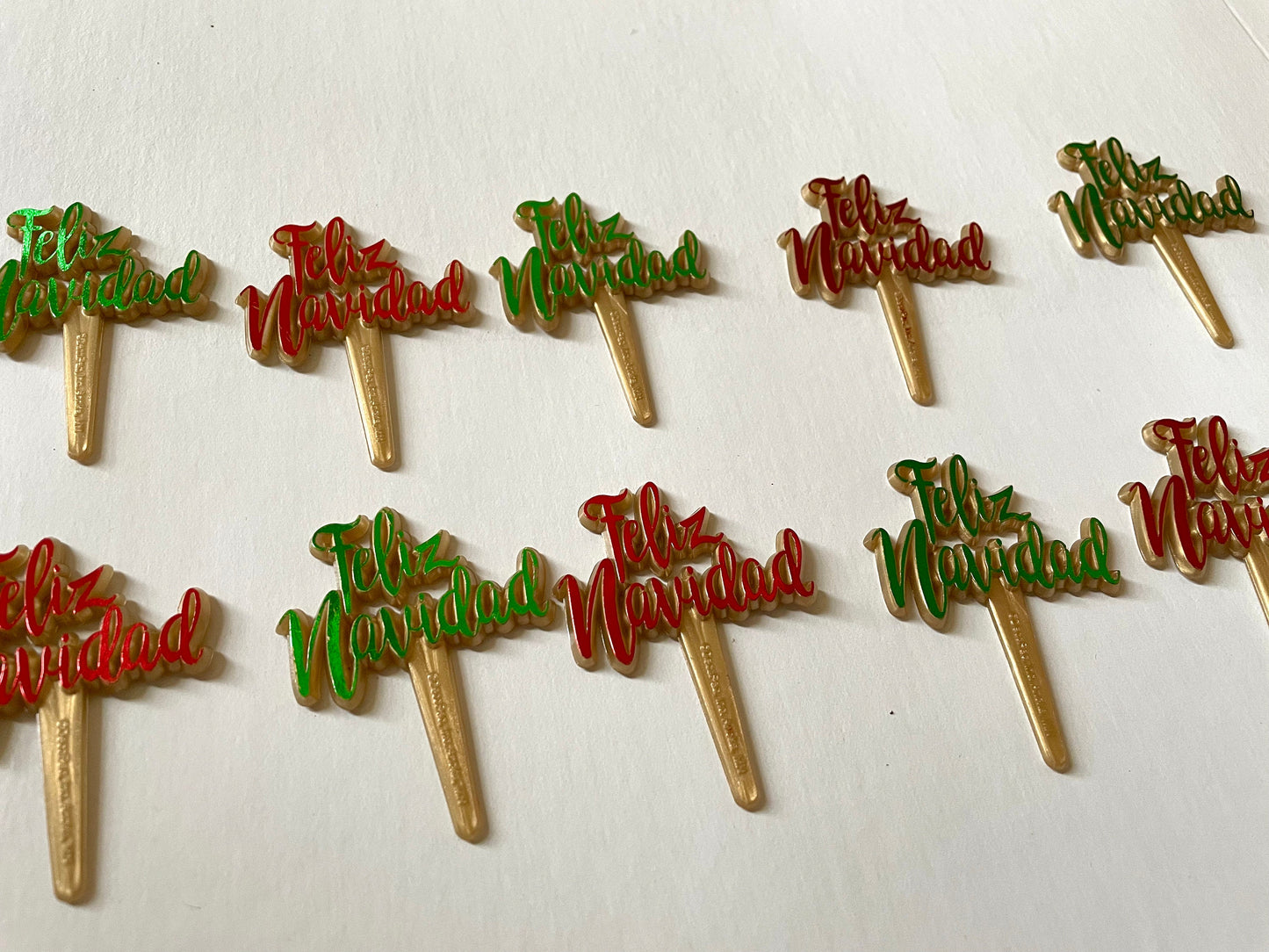 Pair of red and/or green iridescent plastic cake toppers - Feliz Navidad