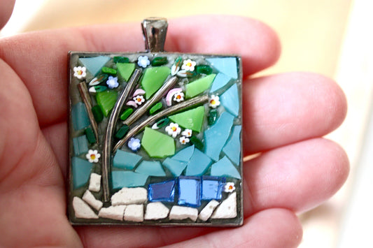My handmade mosaic necklace - "Tree over pond" - ceramic and glass with blue mirrored "pond" and hand cut millefiori flowers
