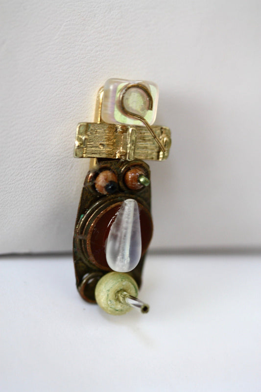 Meet "Joe."  Joe is a really cool assemblage art guy who can be transformed into a necklace, pin, magnet or ring