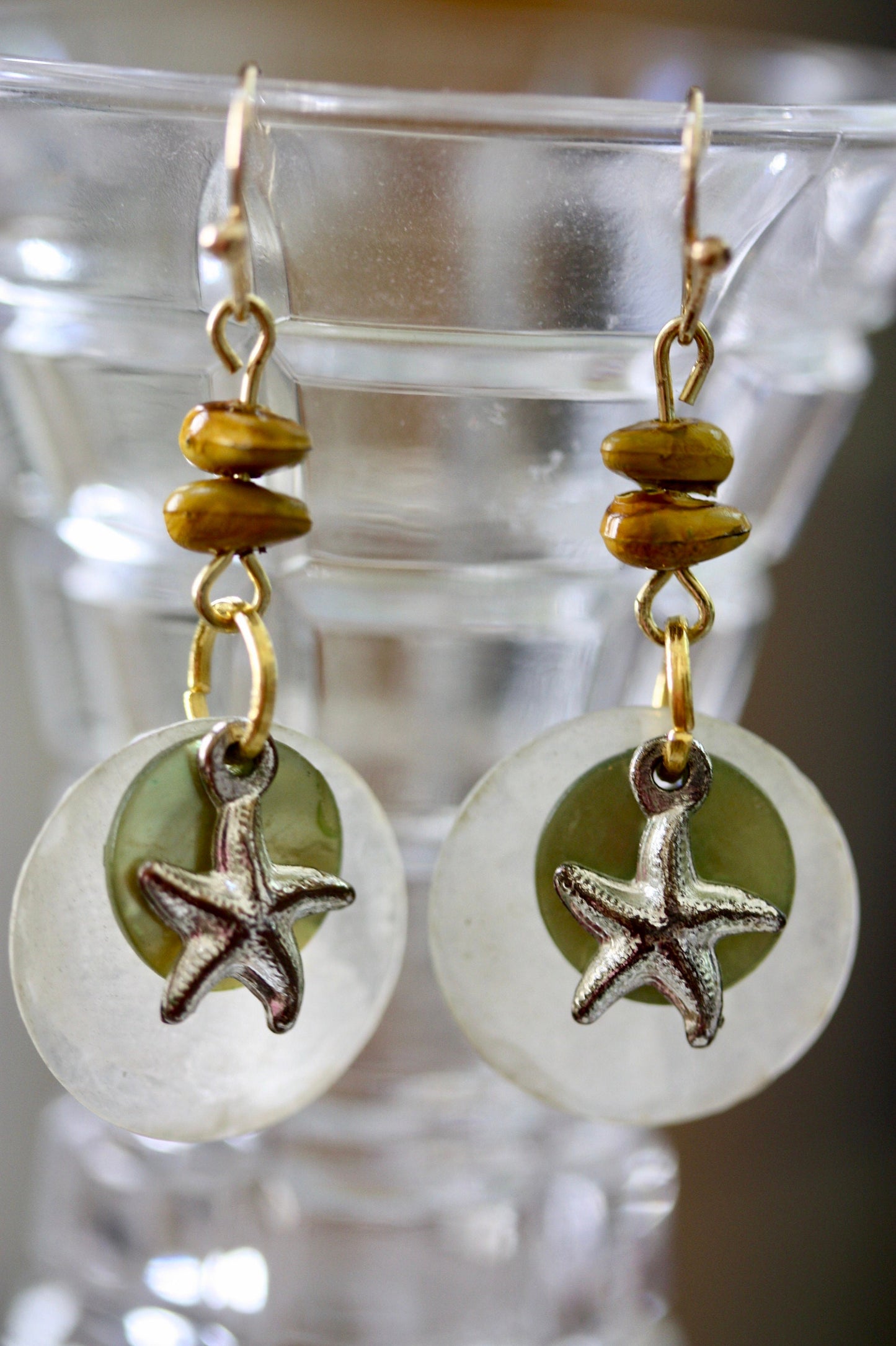 Mixed materials - green mother of pearl, metal starfish and yellow wood - beach themed dangle earrings