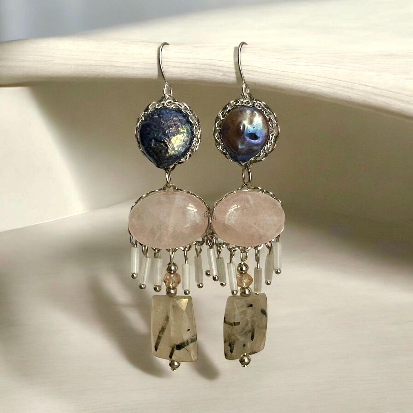 One-of-a-kind dangle earrings made with gray cultured pearls, rose quartz, Rutilated Quartz and white tube glass dangles. Sterling ear wires