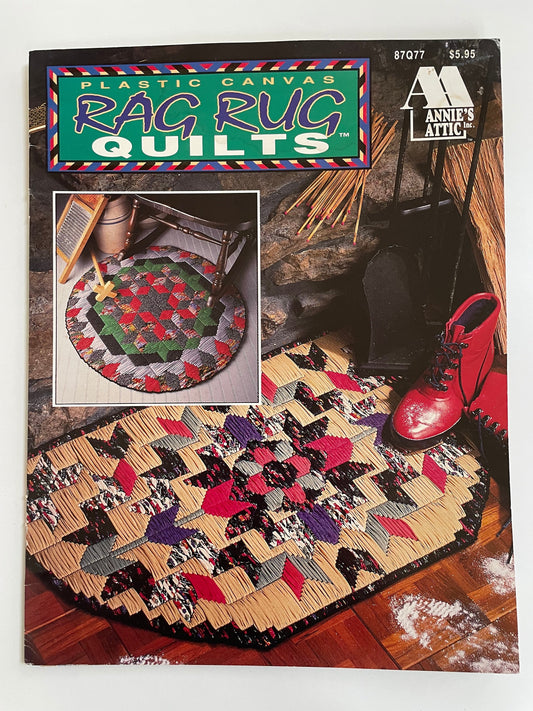 May include: Plastic canvas rag rug quilt pattern with a red, green, black, and white geometric design. The pattern is titled 'Rag Rug Quilts' and is from Annie's Attic. The pattern number is 87077 and the price is $5.95.