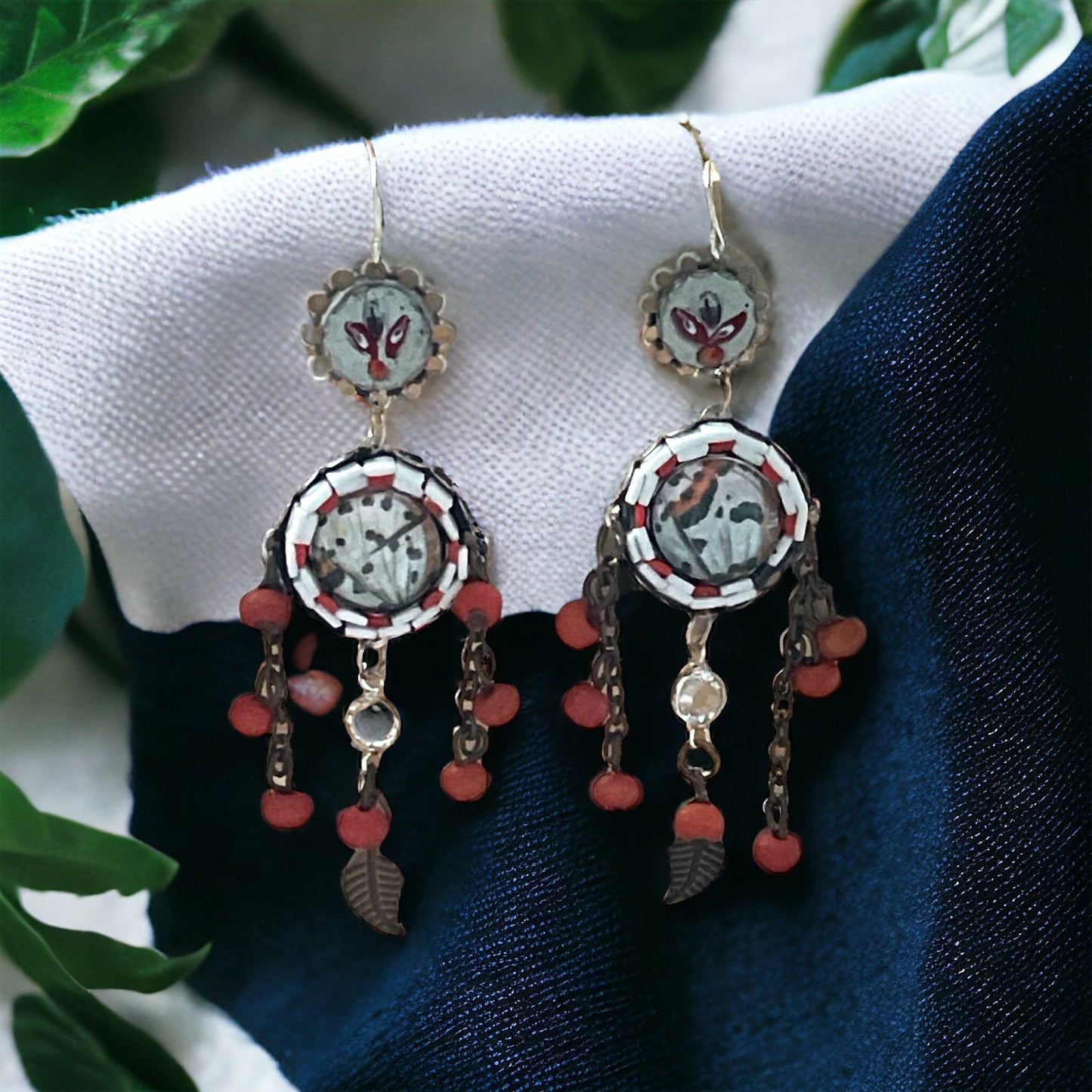 Hand cut micro mosaic millefiori glass dangle earrings surrounding butterfly wing image with orange wood dangles and feather charms