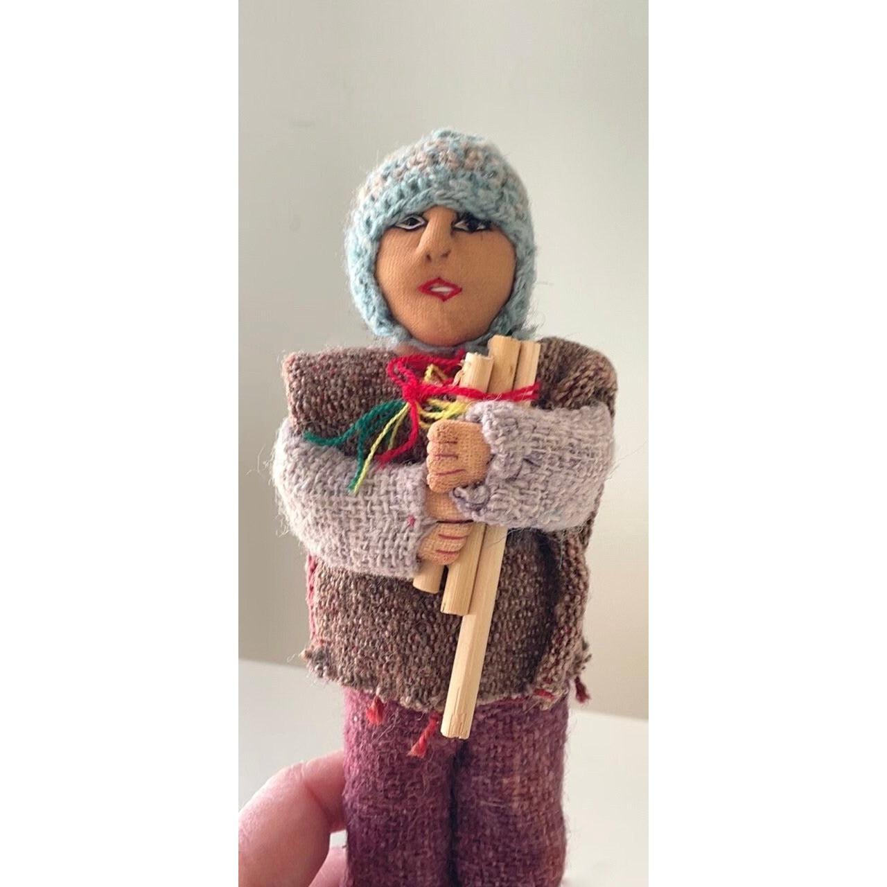 Vintage Bolivian man playing panpipes - collectible folk art doll with handmade woven wool clothing