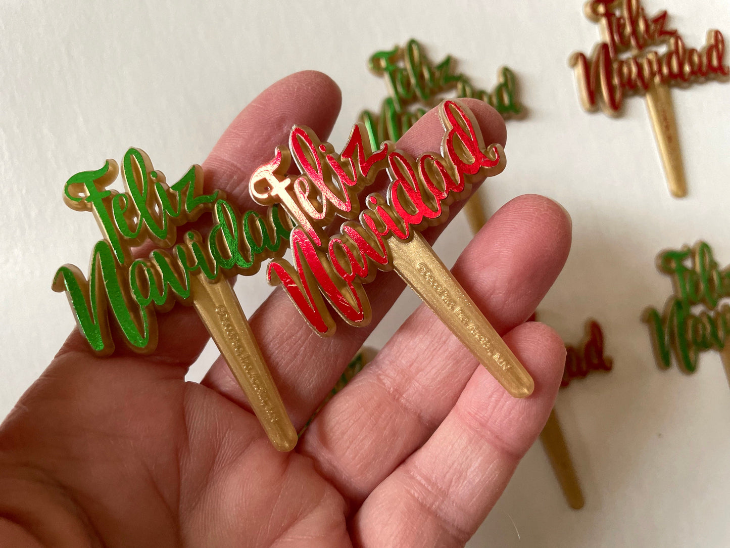 Pair of red and/or green iridescent plastic cake toppers - Feliz Navidad