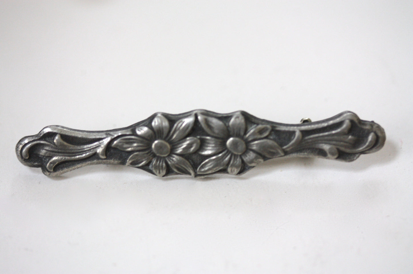 Intricately carved floral vintage bar pin