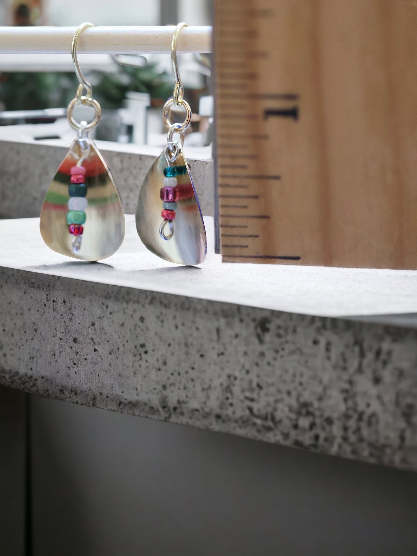 Gently curved silver leaf drop earrings with colored glass seed bead dangles