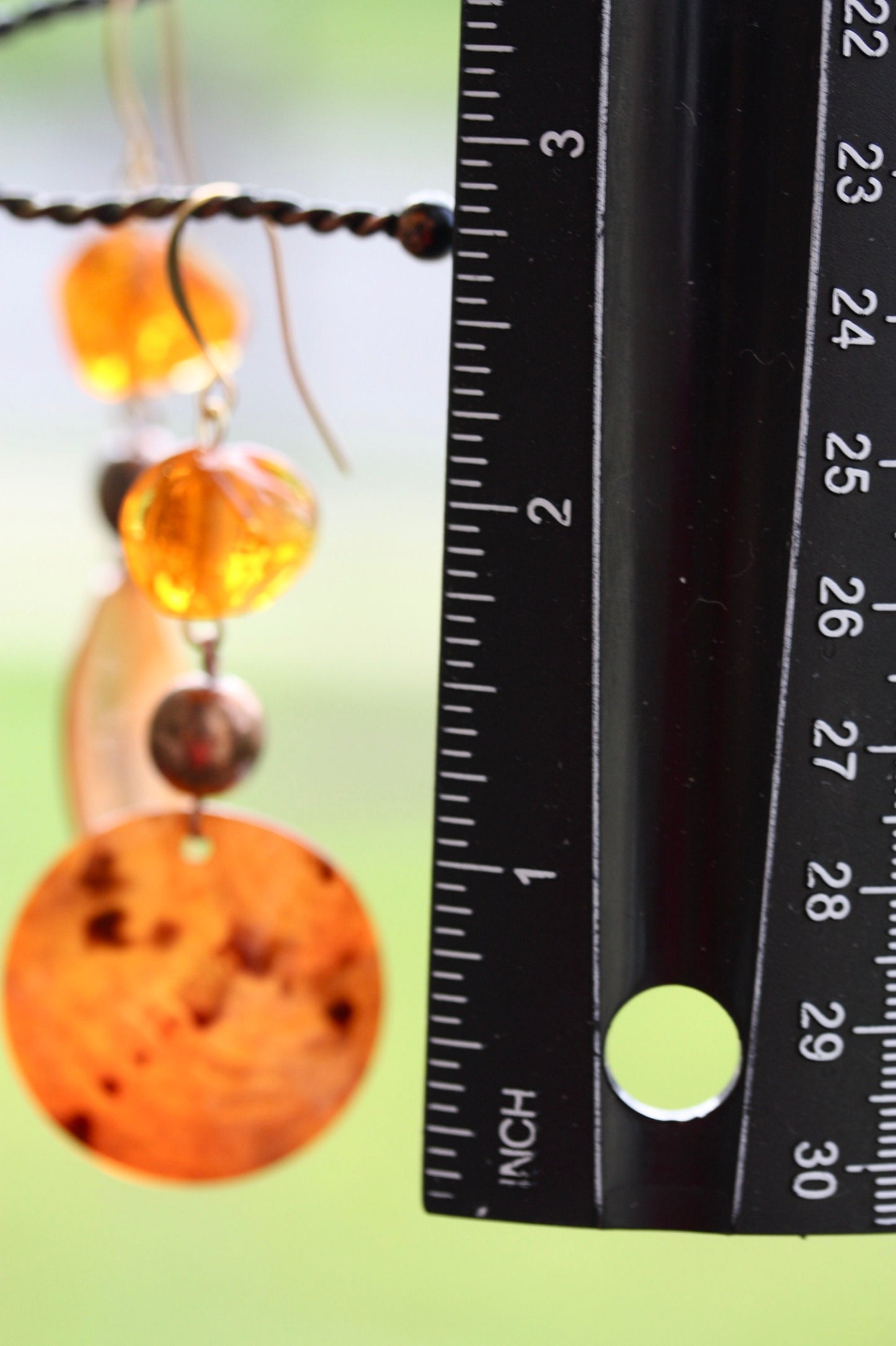 Handmade dangle earrings composed of upcycled orange blown glass, orange mother of pearl and copper beaded spacer beads