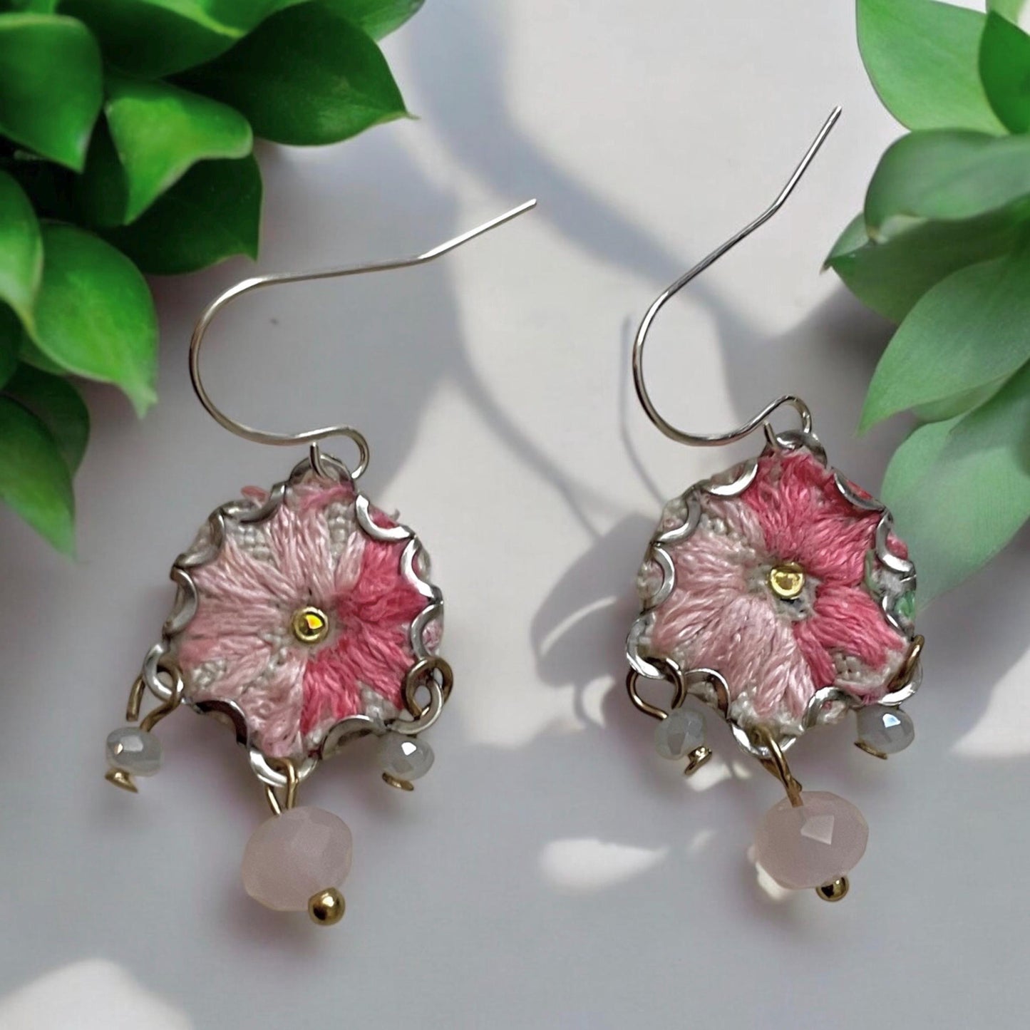 Handmade shades of pink mixed media earrings made with embroidery from a vintage linen table runner, combined with tiny dangles