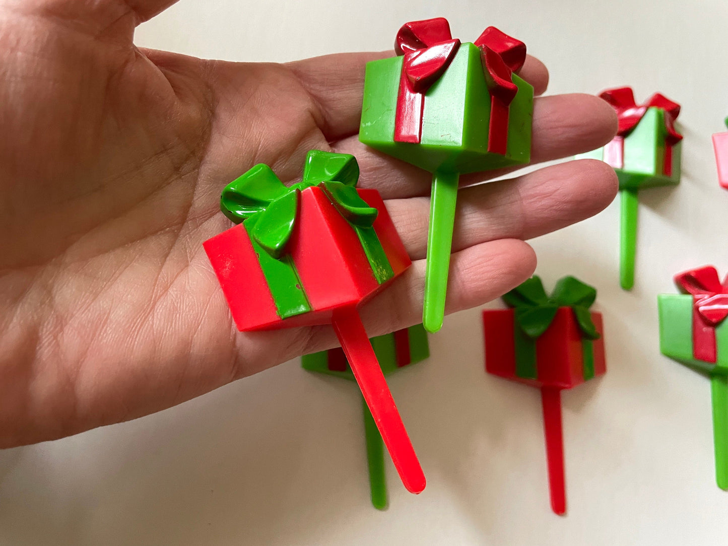 One dozen christmas cupcake toppers - Mix of red and green 3D plastic cake toppers - little wrapped packages with bows