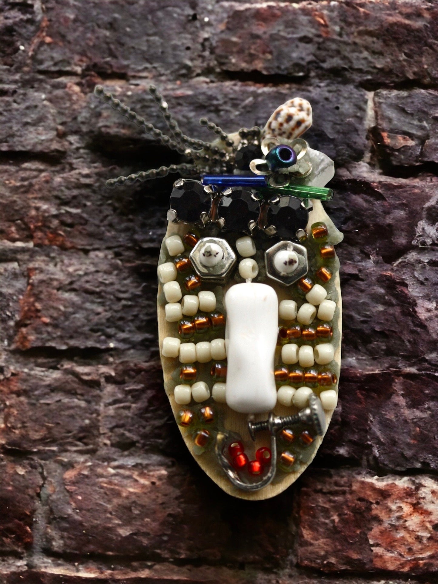 Meet "Sabina."  Sabina is a really cool assemblage art gal who can be transformed into a necklace, pin or magnet