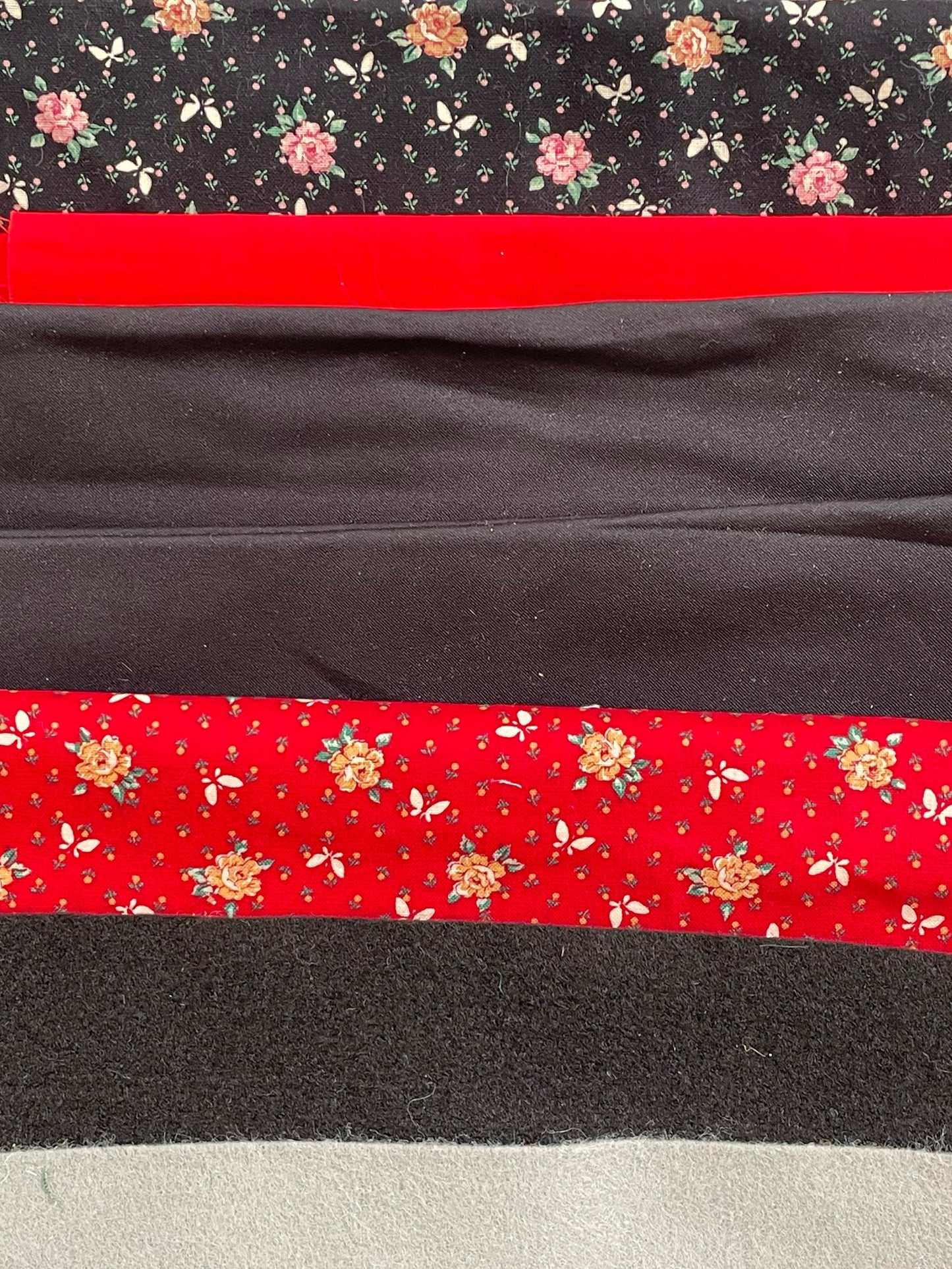 Lot of vintage fabric remnants - reds and blacks, plain and floral