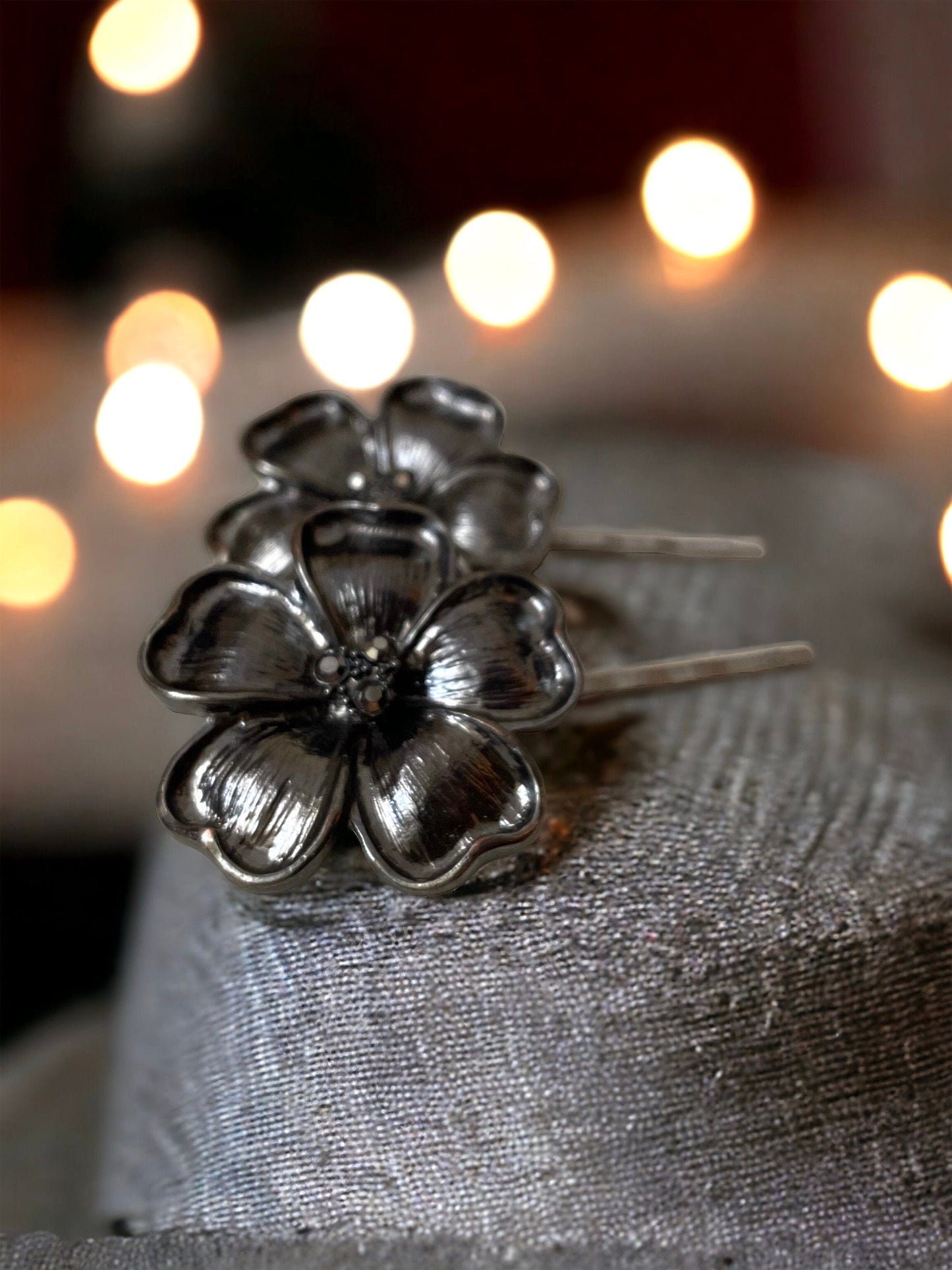 Pair of black flower hair pins with rhinestone centers