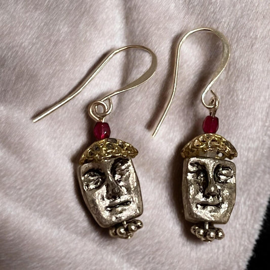 Unique silver tone face earrings with mixed metal and red crystals