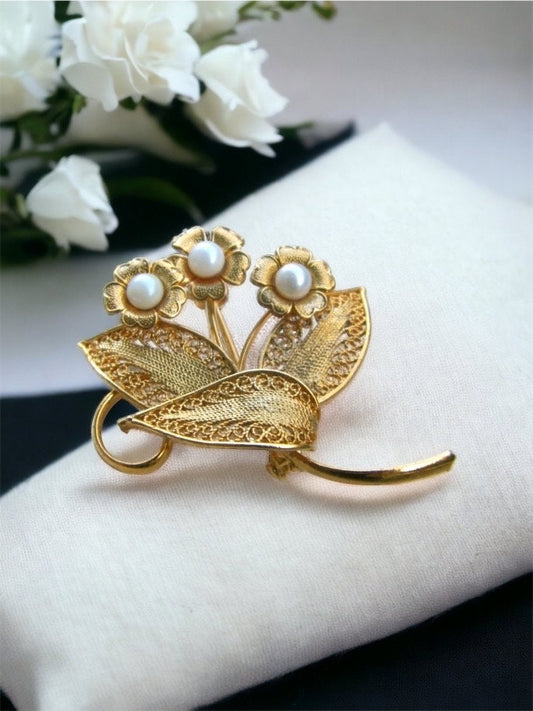Detailed vintage filigree floral pin with faux pearls